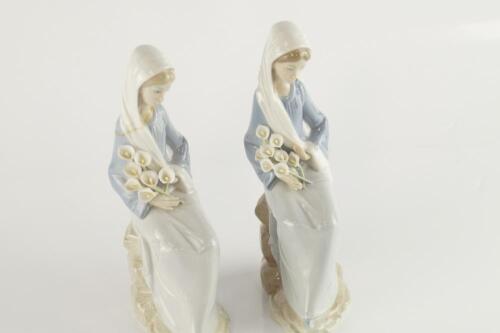 A pair of Lladro lady figures