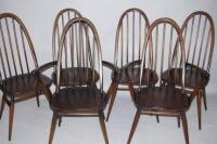 A set of six dark oak Ercol dining chairs