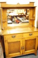 An Arts and Crafts oak mirrorback sideboard