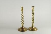 A pair of twisted stem brass candlesticks