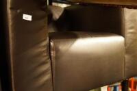 A black leather modern armchair.