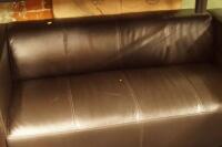 A two seater modern style leather sofa.