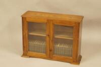 Dickens (Charles). Pocket book edition collection housed in a pine cabinet with two glazed doors