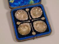 A set of four Victorian silver shell shaped salts