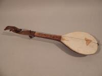 An early 20thC carved African tribal hardwood mandolin