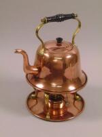 A Victorian Arts & Crafts style copper and brass kettle on stand