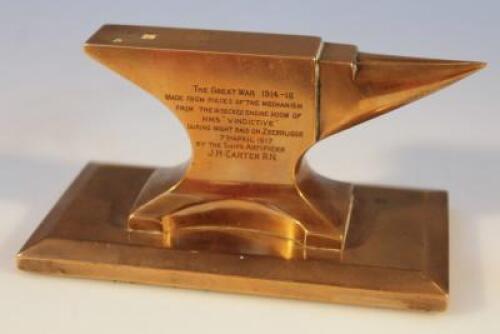 A brass paperweight in the form of an anvil