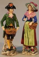 A pair of Sitzendorf procelain figure groups of fruit sellers