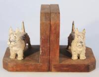 A pair of oak and cast metal bookends