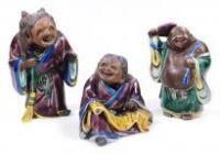 A set of three oriental pottery figures of immortals