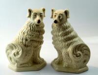 A pair of early 20thC Staffordshire pottery comforter dogs