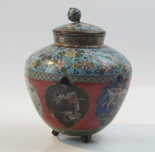 An Oriental style cloisonne ovoid jar and cover on three feet