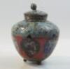 An Oriental style cloisonne ovoid jar and cover on three feet