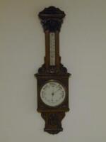 A Victorian carved oak barometer