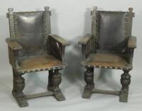 An unusual pair of early 20thC leather and oak open armchairs