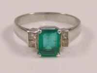 An emerald and diamond ring