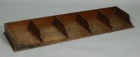 An early 20thC five division oak desk mounted stationery rack