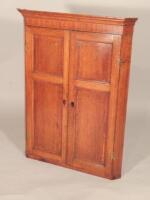 A late 18th/early 19thC oak and mahogany crossbanded hanging corner cabinet