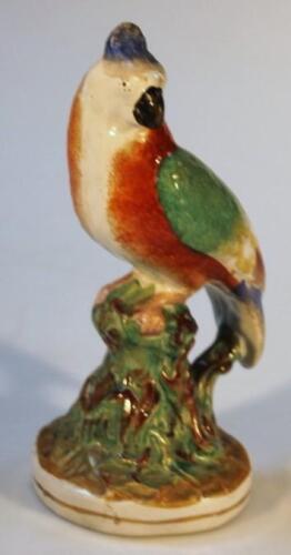 A mid-19thC Staffordshire pottery parrot figure