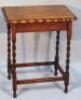 A 1920s oak sewing table