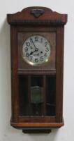 A 1920s oak wall clock