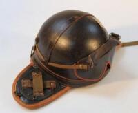 A tank crew leather clad helmet with ear flaps.