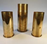 Three brass ordnance shell cases.