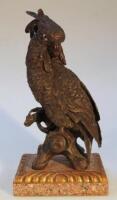 A bronzed figure of a cockatoo