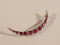 A ruby and diamond crescent brooch