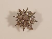 A diamond star brooch