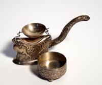 A silver strainer stand and salt. (2)