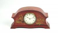 A 1920s red lacquer and chinoiserie mantel clock.