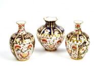 A Royal Crown Derby garniture of vases