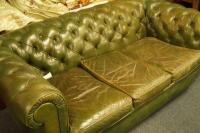 A green buttoned back leather three piece suite