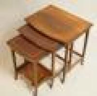 A nest of three Edwardian style string inlaid mahogany occasional tables.