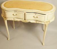 A French style parcel gilt and cream painted kidney shaped writing/dressing table