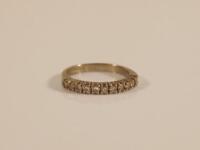 An 18ct white half hoop eternity ring