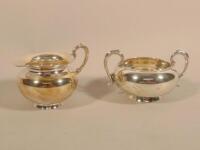 A white metal two handled sugar bowl and matching jug