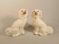 A pair of late Victorian Staffordshire spaniel comforter dogs