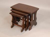 A nest of three Ercol mid brown stained elm tables