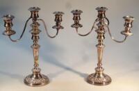 A pair of silver plated three branch candelabra