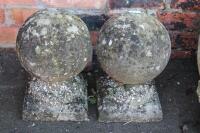 A pair of stone gate finials