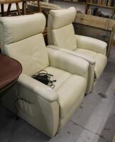 A pair of cream leather electric reclining armchairs