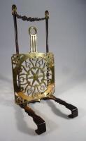 An early 20thC iron and brass range trivet