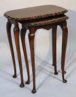 A mahogany finish nest of three tables