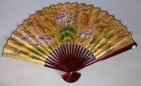 An oriental red lacquer fan
