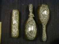 A late Victorian silver backed brush set