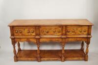 A reproduction medium oak dresser base in 18thC style