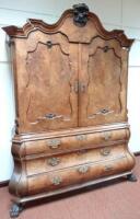 A 19thC Dutch walnut bombe cabinet