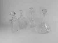 Four pressed glass decanters